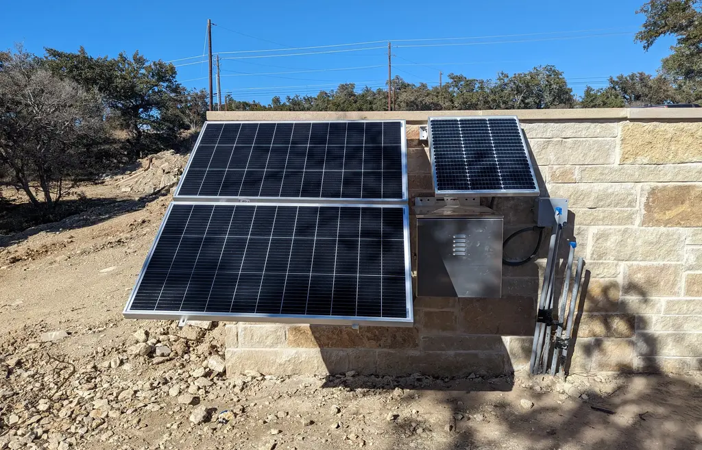 3 Solar panels angled to capture the most sunlight. 2 on left are the same size, one on right is a third of their size
